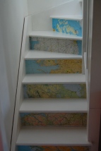 Winding stairs with maps on risers.